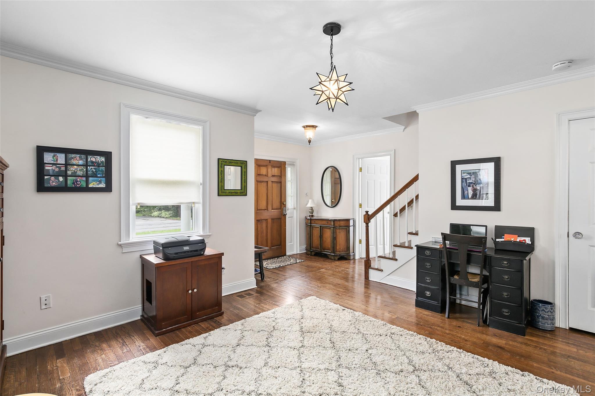 8 Goldwin Street Rye, NY 10580 - Photo 2 of 25 a living room with furniture a window and a chandelier