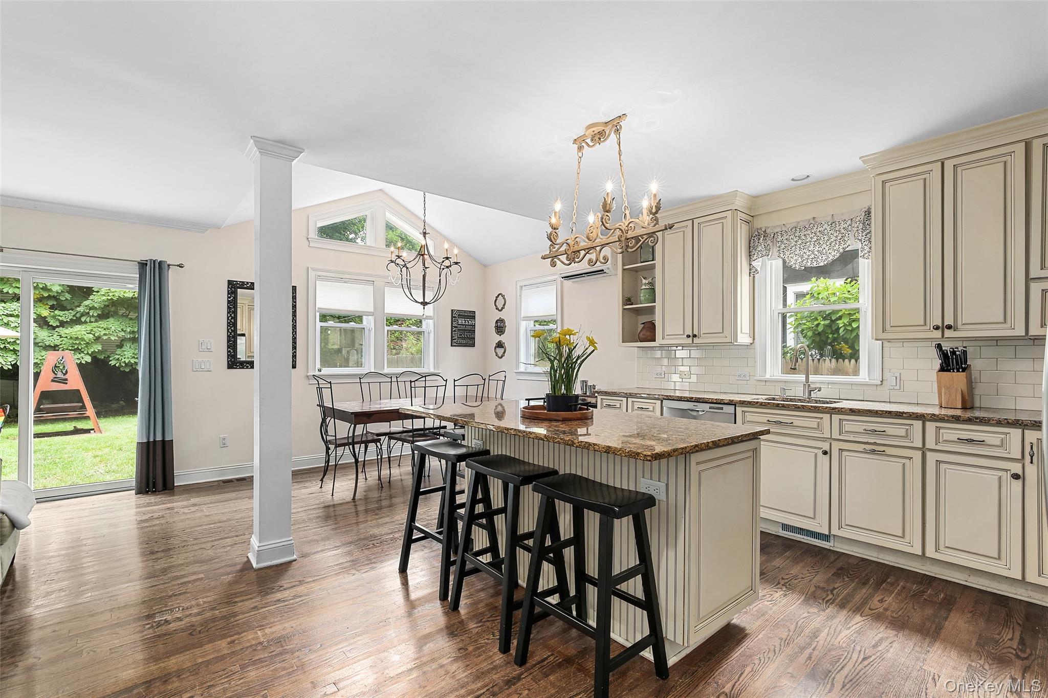 8 Goldwin Street Rye, NY 10580 - Photo 4 of 25 a kitchen with stainless steel appliances granite countertop wooden floor a dining table and chairs