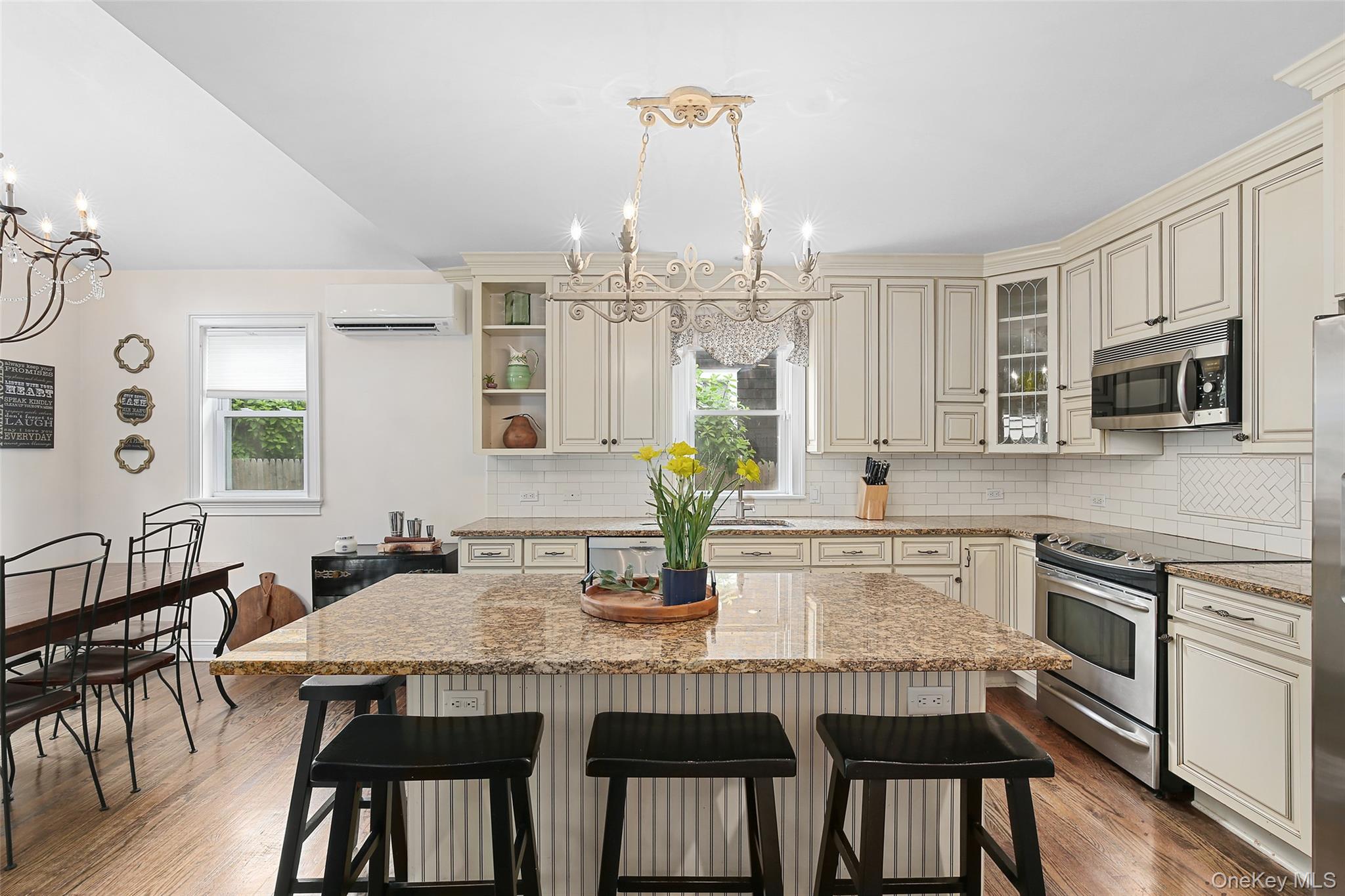 8 Goldwin Street Rye, NY 10580 - Photo 5 of 25 a kitchen with stainless steel appliances granite countertop a dining table chairs and granite counter tops
