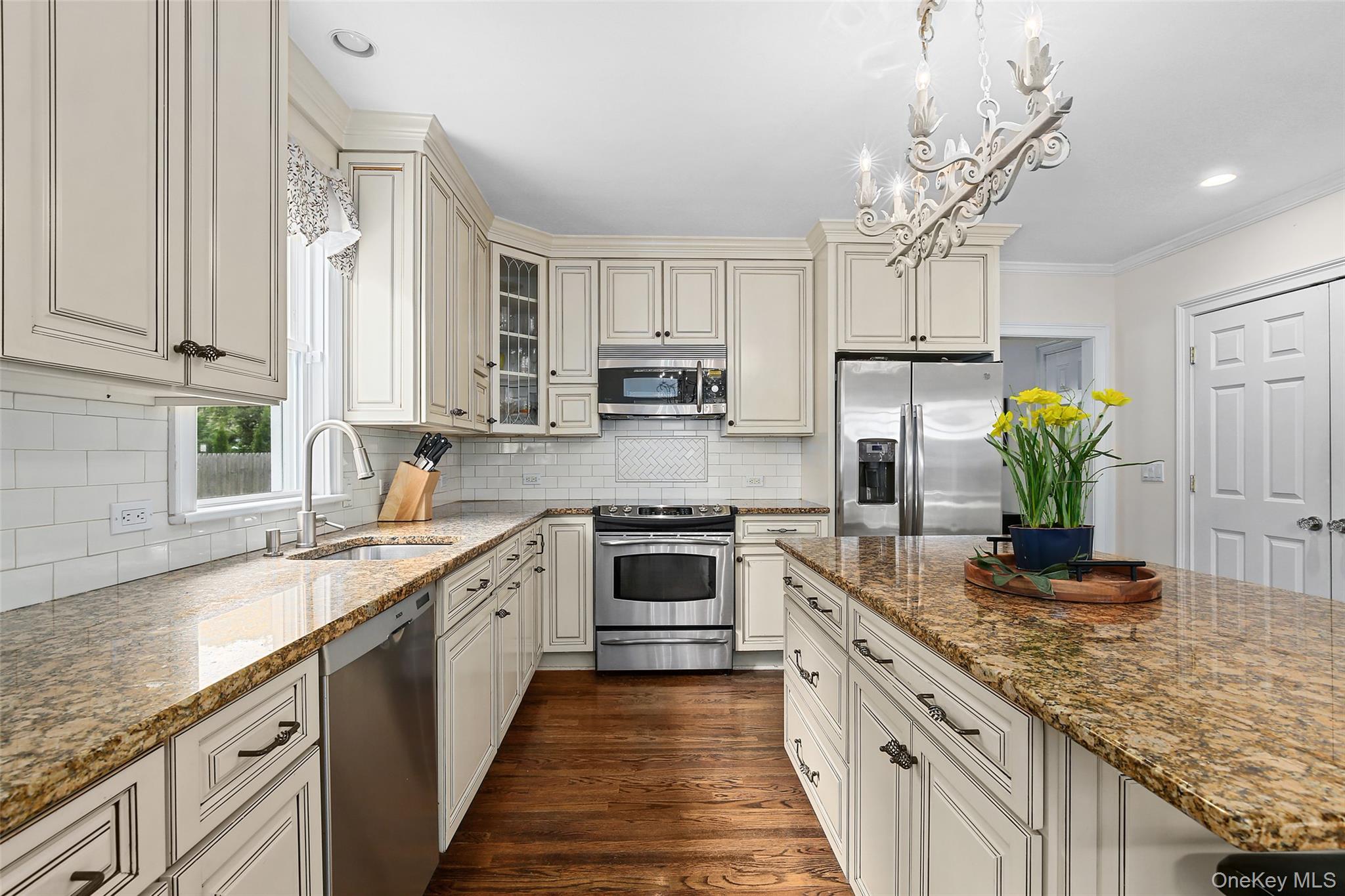 8 Goldwin Street Rye, NY 10580 - Photo 8 of 25 a kitchen with stainless steel appliances granite countertop a sink a stove and cabinets