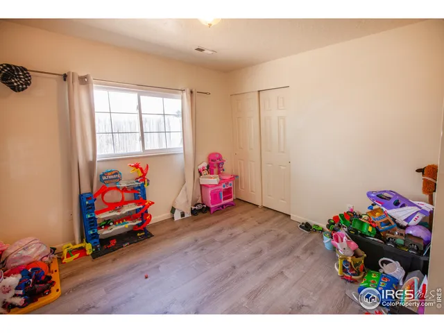 a room with toys and dresser with wooden floor