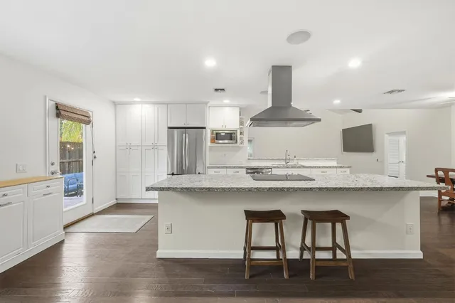 a bedroom with a bed and a lamp on dresser