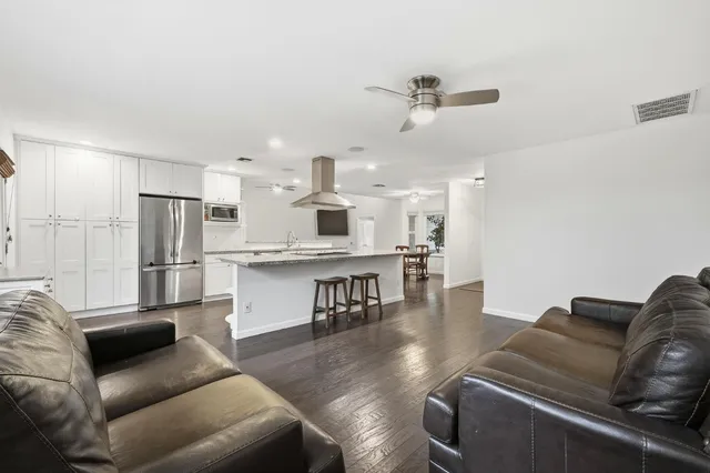 a bathroom with a granite countertop sink a toilet and a mirror