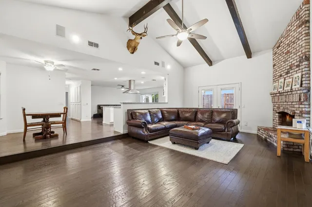 a living room with furniture and wooden floors