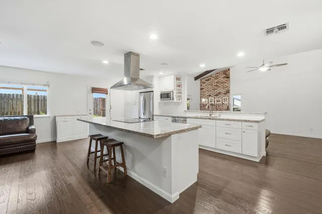 a room with a window and a dresser