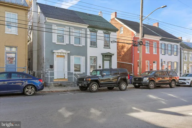 a car parked in front of a big building