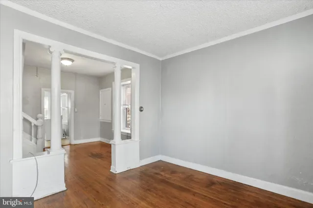 an empty room with wooden floor