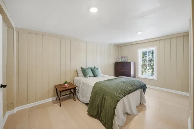 a spacious bedroom with a bed and a window