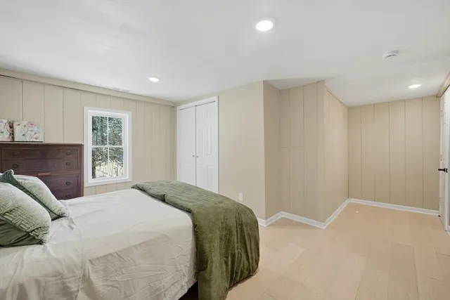 a bedroom with a large bed and a window