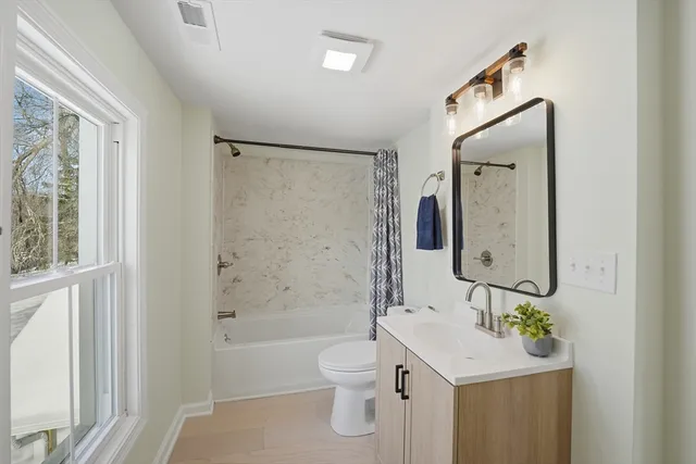 a bathroom with a toilet a sink and a bathtub
