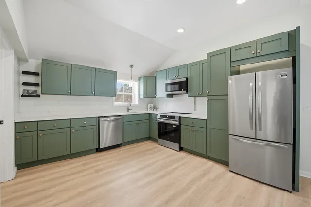 a kitchen with a refrigerator and a sink