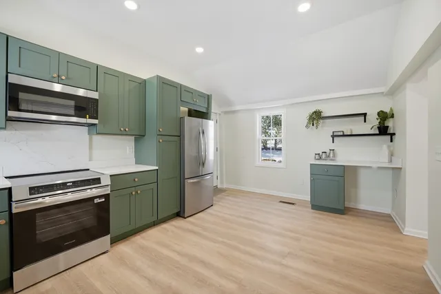 a kitchen with a refrigerator stove and microwave