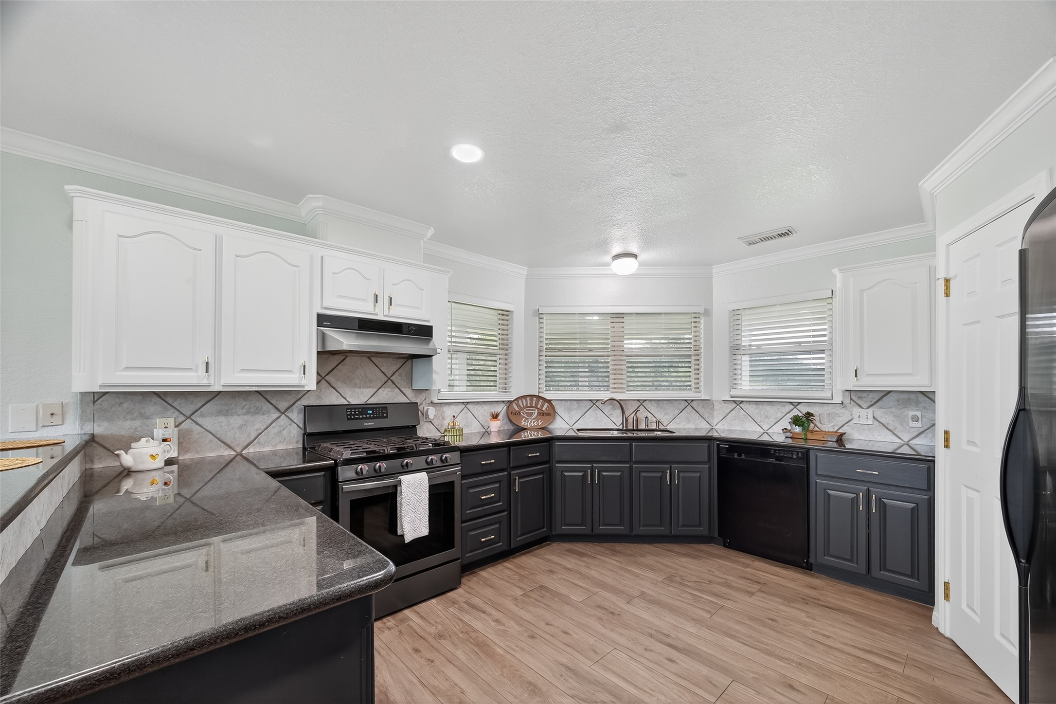1030 Ginger Street Santa Fe, TX 77517 - Photo 15 of 50 a kitchen with stainless steel appliances granite countertop a sink stove and cabinets