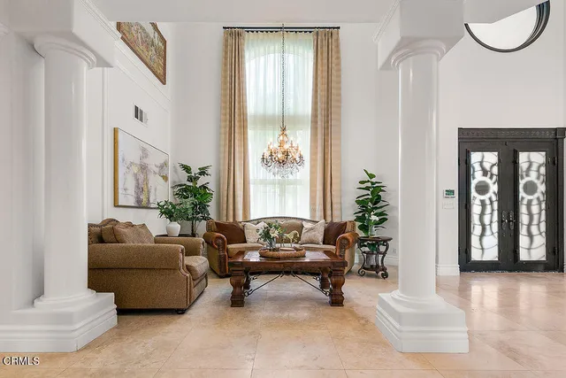 a room with pool table flat screen tv and windows