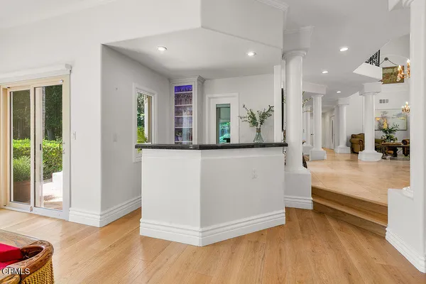 a kitchen with a white cabinets and window