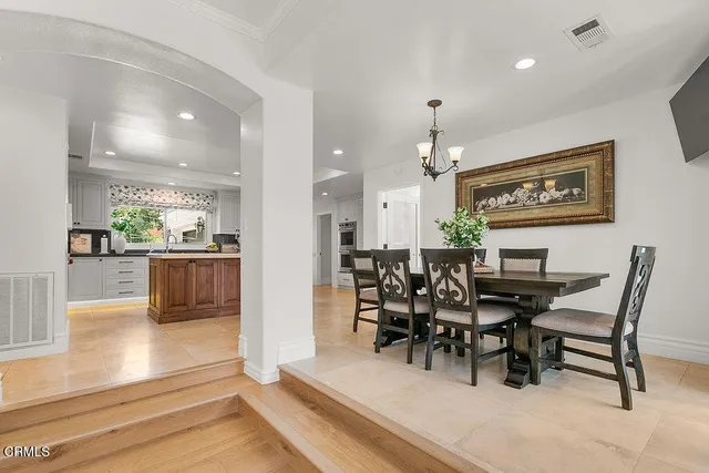 a view of kitchen with stainless steel appliances wooden floor and window
