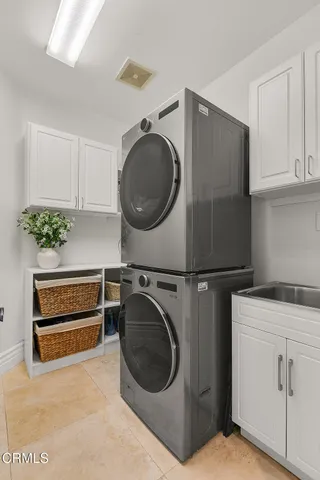 a bedroom with a bed table and a large window