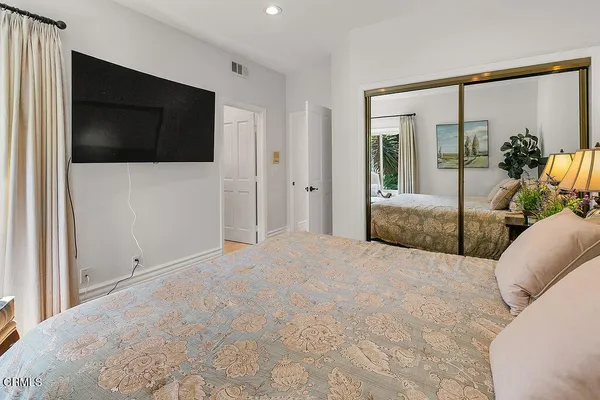 a bathroom with a granite countertop sink mirror toilet and shower