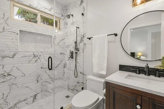 a bathroom with a toilet and a shower