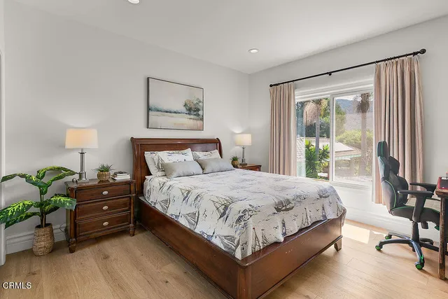 a spacious bathroom with a tub shower and mirror