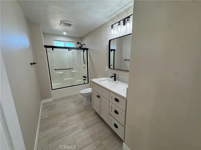 a bathroom with double vanity sink and mirror