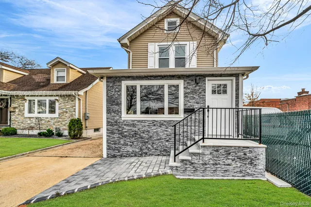 a front view of a house with a garden