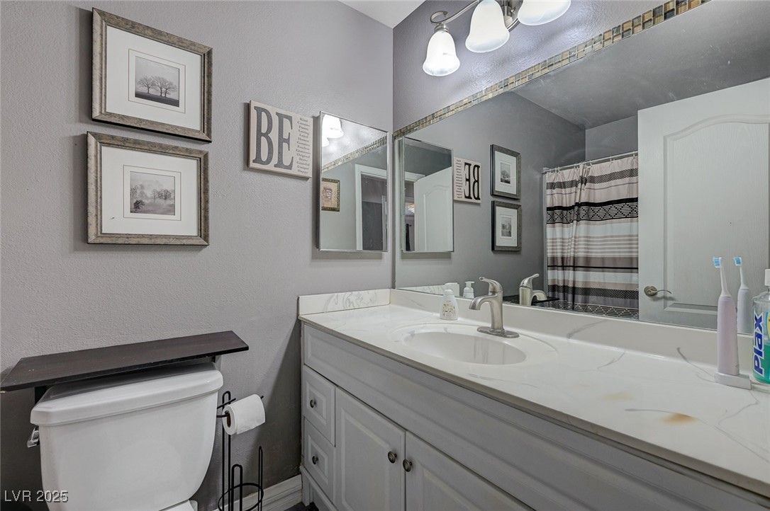 3266 Mountain Spring Road Las Vegas, NV 89146 - Photo 19 of 49 Full bathroom featuring vanity and toilet