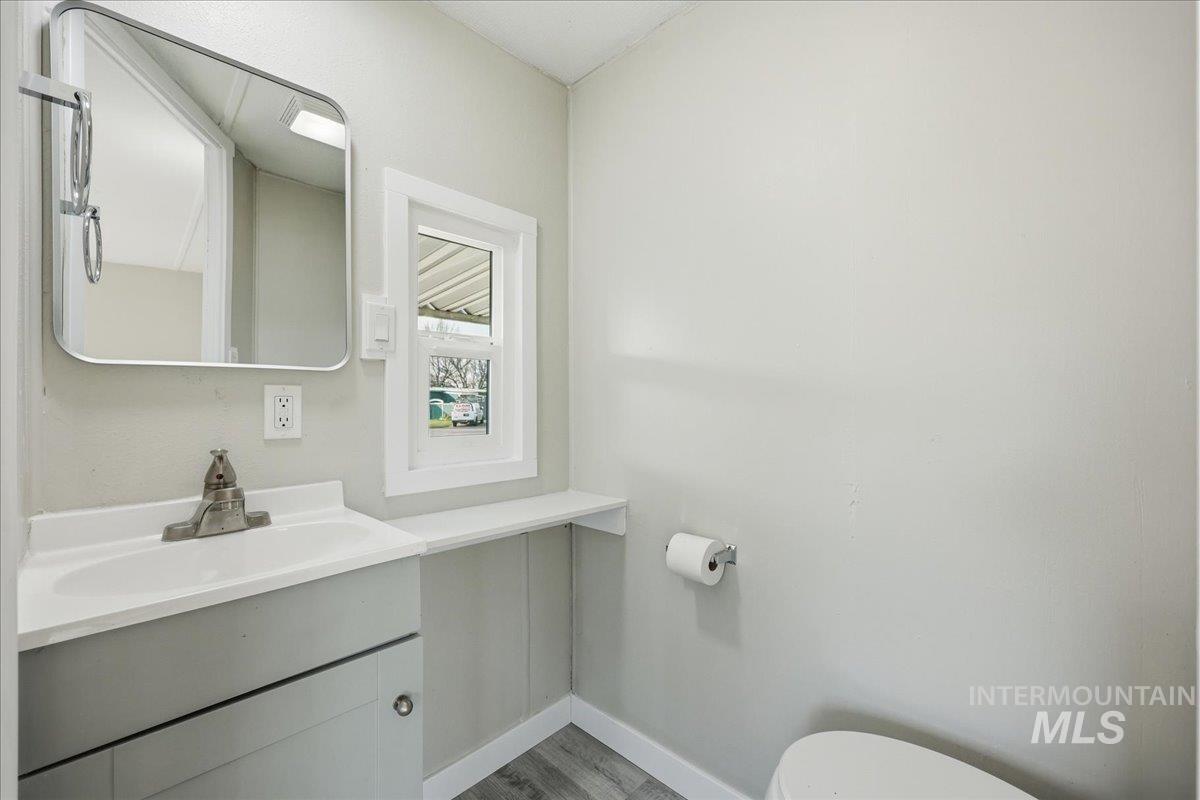 5015 East Ustick Road, Unit 172 Caldwell, ID 83605 - Photo 11 of 21 Bathroom featuring vanity and wood finished floors