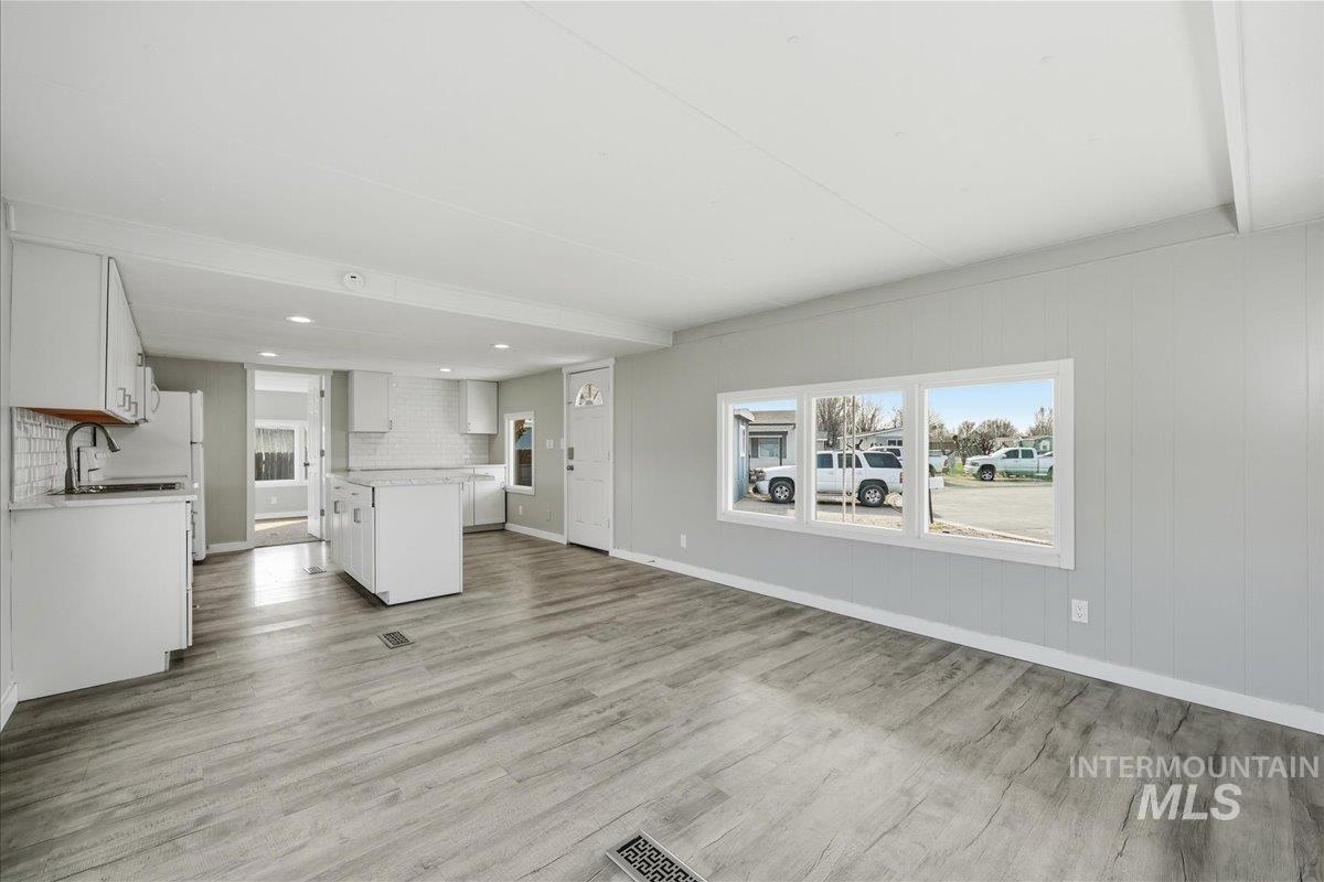 5015 East Ustick Road, Unit 172 Caldwell, ID 83605 - Photo 21 of 21 Unfurnished living room featuring plenty of natural light, light wood-style flooring, and recessed lighting