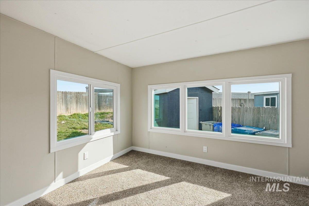 5015 East Ustick Road, Unit 172 Caldwell, ID 83605 - Photo 9 of 21 Empty room featuring light colored carpet and baseboards