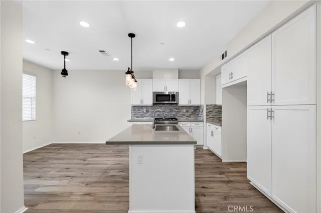 a kitchen with kitchen island a stove a sink and a refrigerator