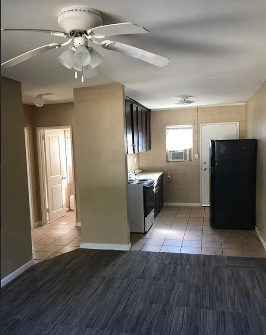 3403 Terminal Court Columbus, GA 31906 - Photo 3 of 8 a view of a kitchen with a refrigerator a ceiling fan and wooden floor