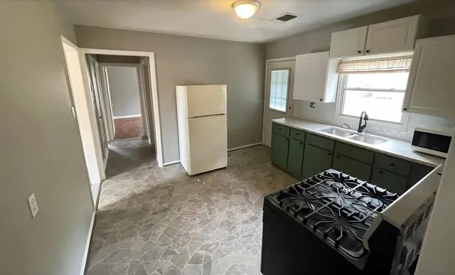 a kitchen with a stove and a refrigerator