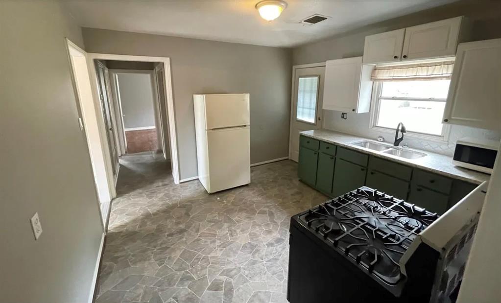 2425 Denison Street Denton, TX 76201 - Photo 1 of 2 a kitchen with a stove and a refrigerator