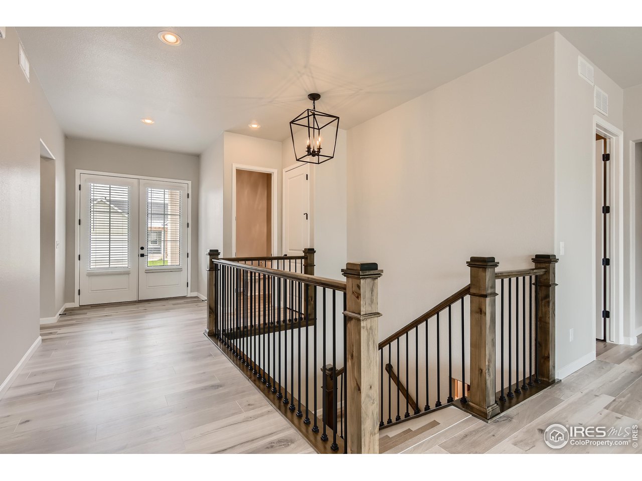 261 Cornelia Drive Windsor, CO 80550 - Photo 4 of 16 a view of a hallway with wooden floor and windows