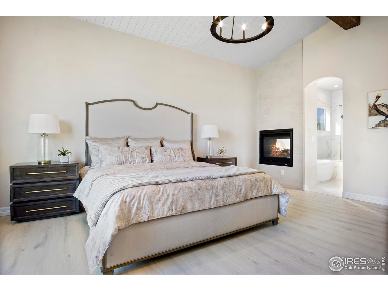 261 Cornelia Drive Windsor, CO 80550 - Photo 5 of 16 a bedroom with a bed and a chandelier