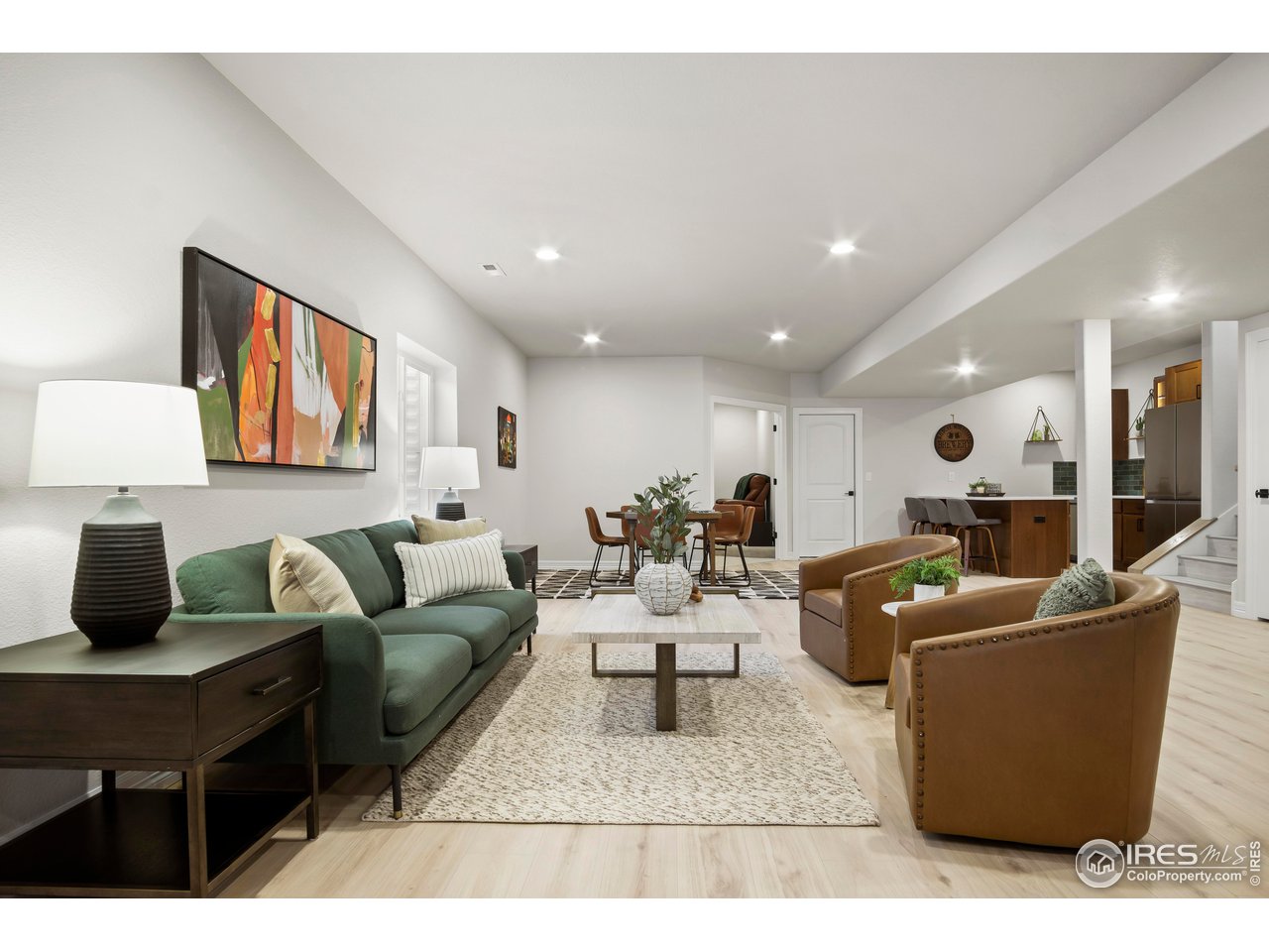 261 Cornelia Drive Windsor, CO 80550 - Photo 8 of 16 a living room with furniture a rug and a painting