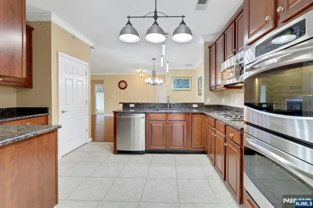 a large kitchen with a stove top oven cabinets a sink and a counter top space