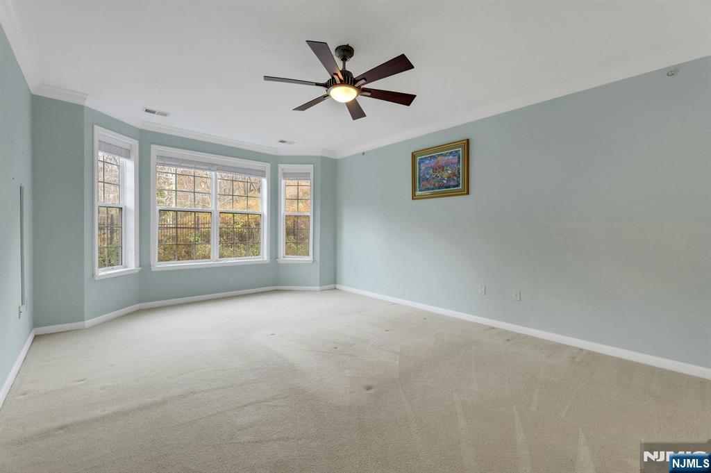6 Cliff Road, Unit D2 Woodland Park, NJ 07424 - Photo 15 of 40 a view of an empty room with a ceiling fan and window