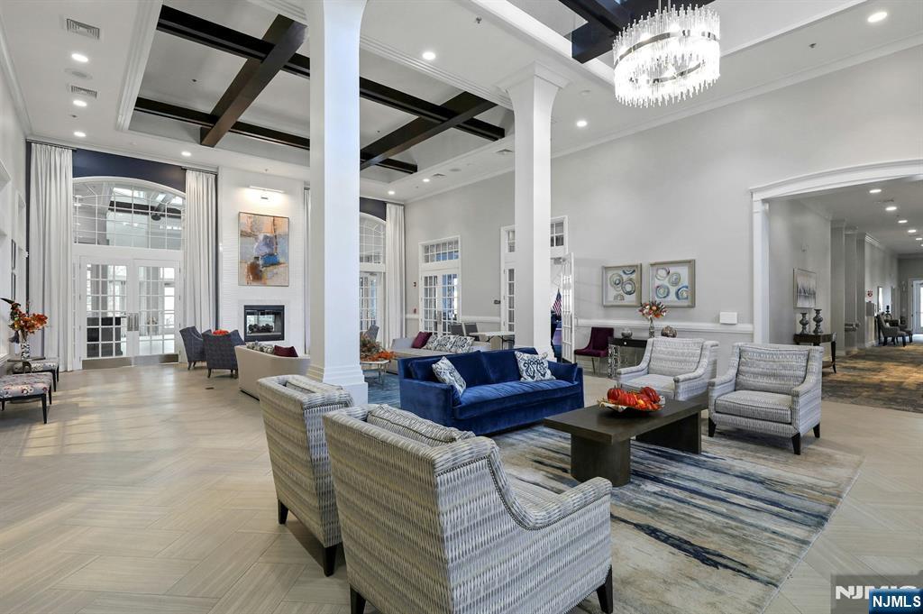 6 Cliff Road, Unit D2 Woodland Park, NJ 07424 - Photo 31 of 40 a living room with furniture a chandelier and a fireplace