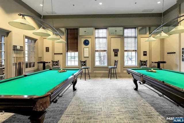 a view of a room with lots of furniture and wooden floor