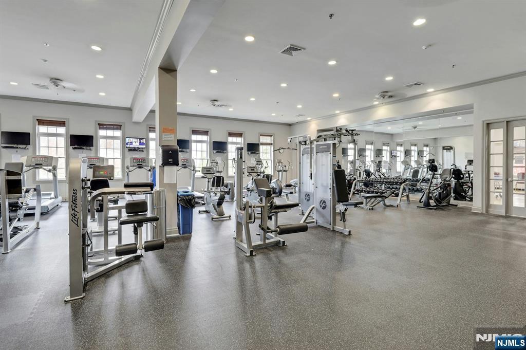 6 Cliff Road, Unit D2 Woodland Park, NJ 07424 - Photo 33 of 40 a view of a room with lots of furniture and wooden floor