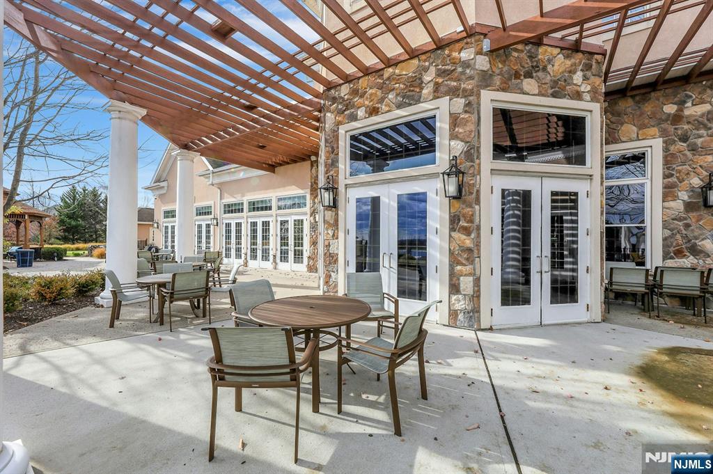 6 Cliff Road, Unit D2 Woodland Park, NJ 07424 - Photo 39 of 40 a view of a dinning table and chairs in the patio