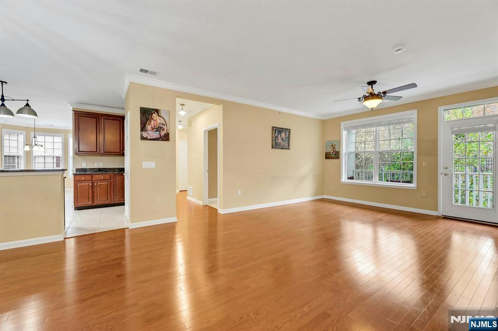 6 Cliff Road, Unit D2 Woodland Park, NJ 07424 - Photo 8 of 40 a view of an empty room with window and wooden floor