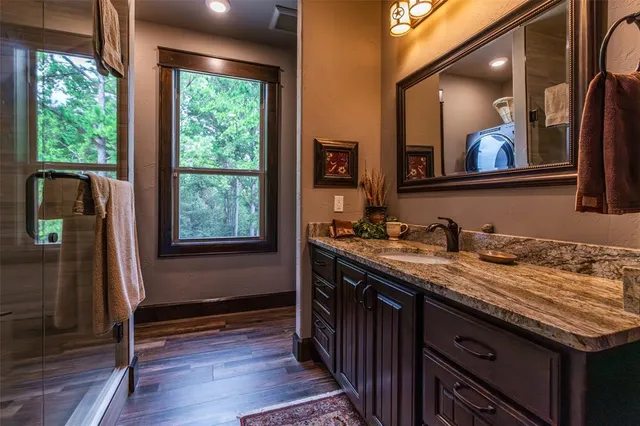 a bathroom with a granite countertop sink and a mirror
