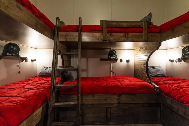 a bedroom with a bed and windows