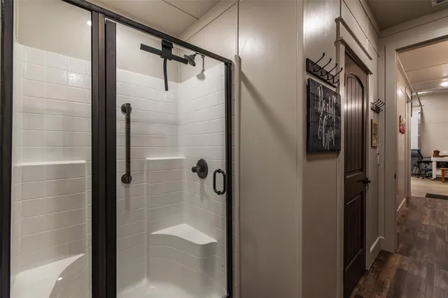 a bathroom with a glass shower door