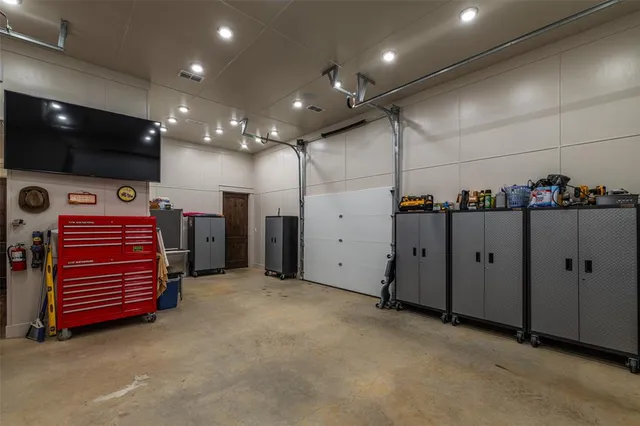 a view of a room with gym equipment and a flat screen tv