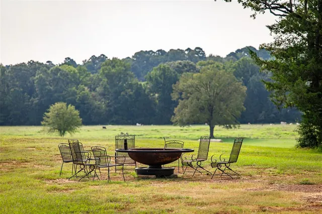 a view of a swimming pool with a table and chairs
