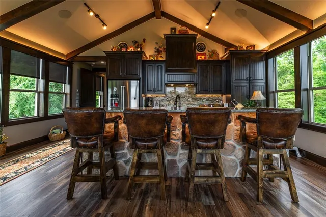 a dining room with furniture and wooden floor